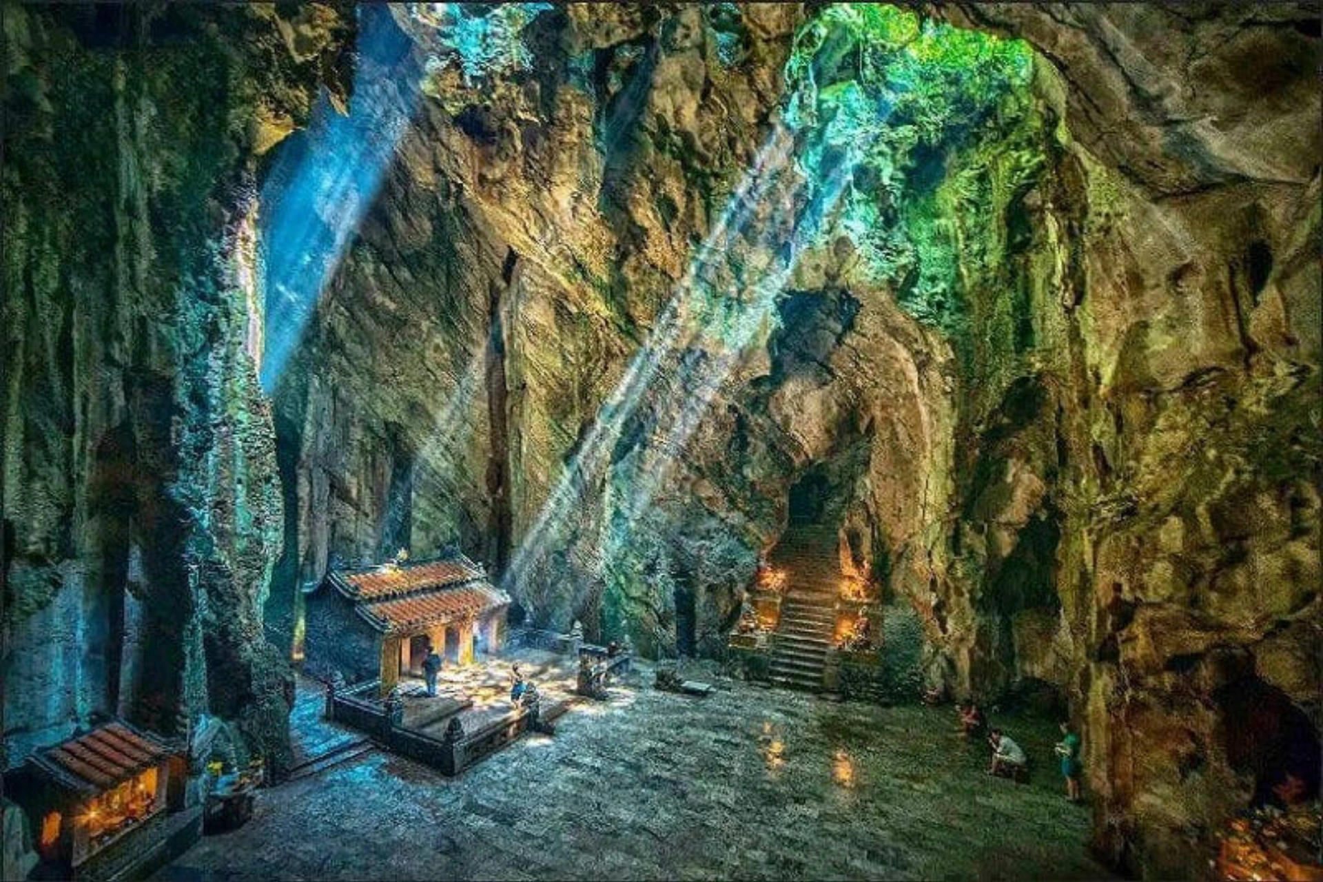 Marble Mountains cave with stone stairs and green moss walls