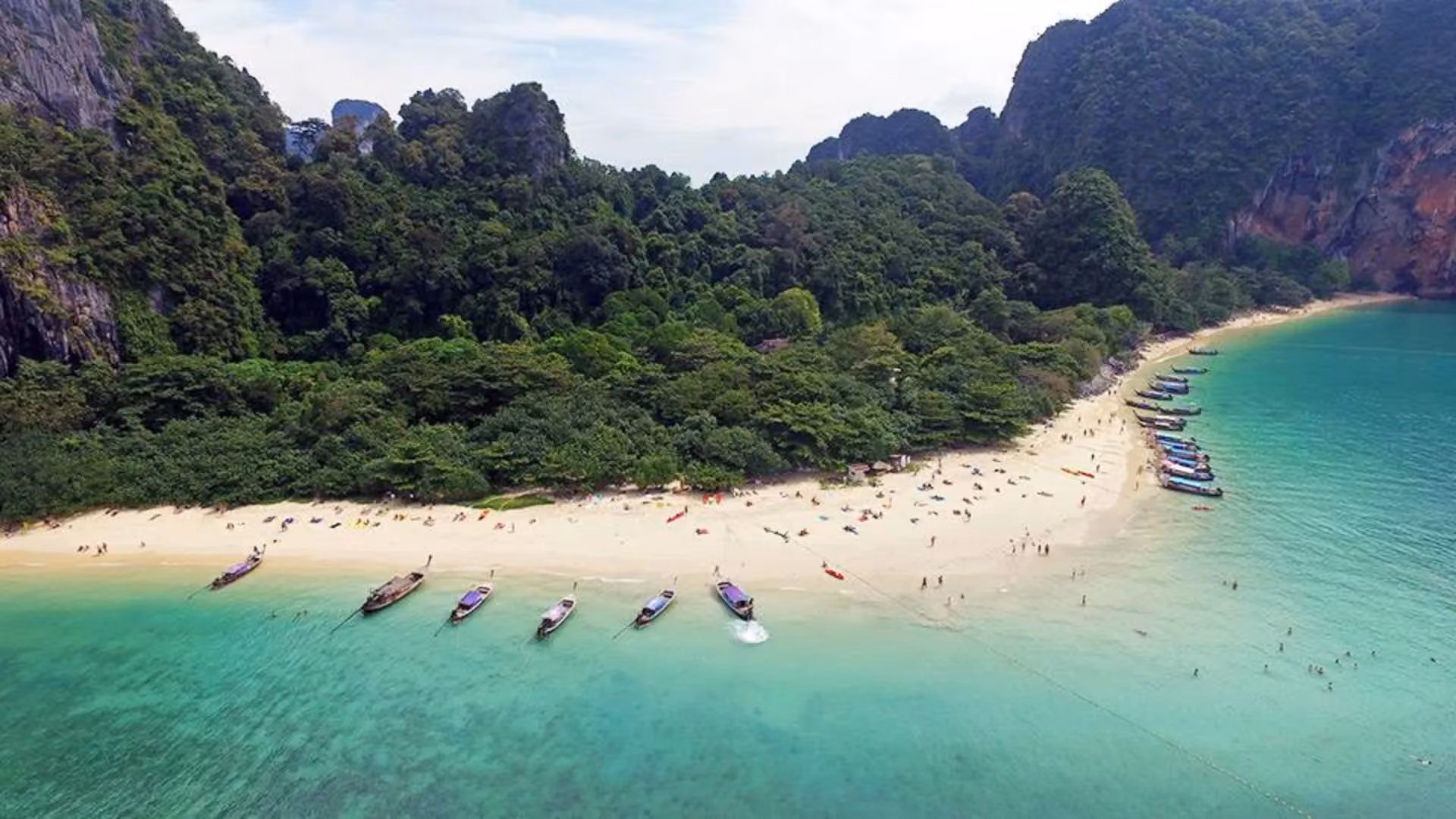 Boats on blue-green water at Krabi beach Thailand