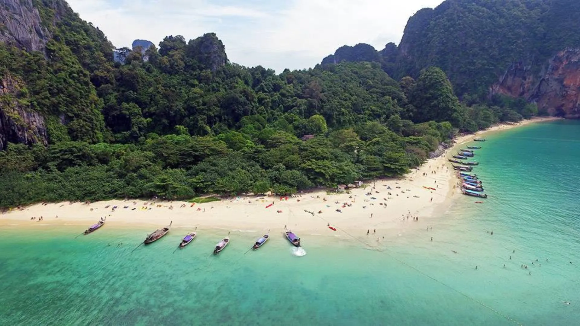 Boats on blue-green water at Krabi beach Thailand