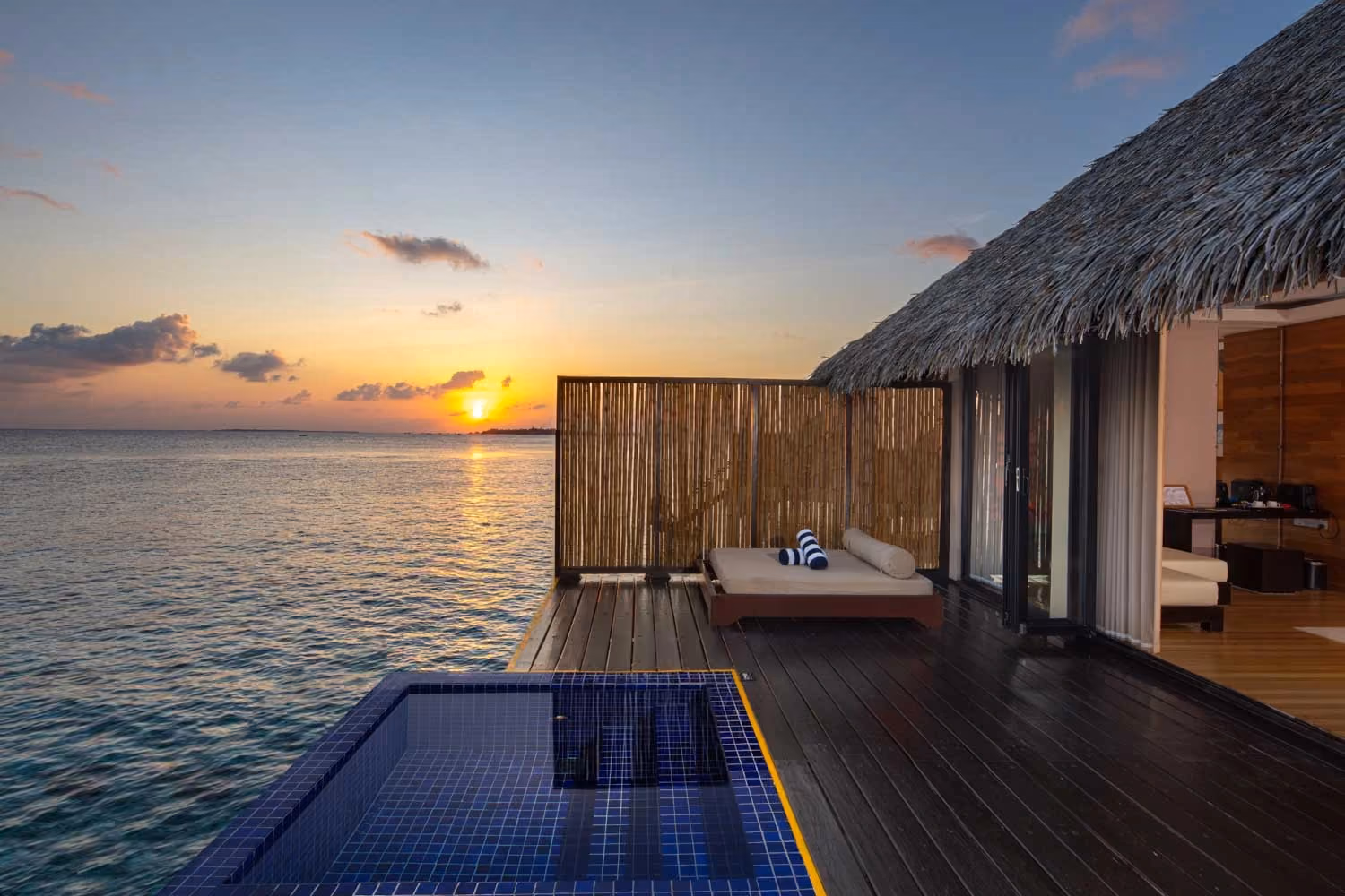 Sunset villa with pool overlooking ocean water