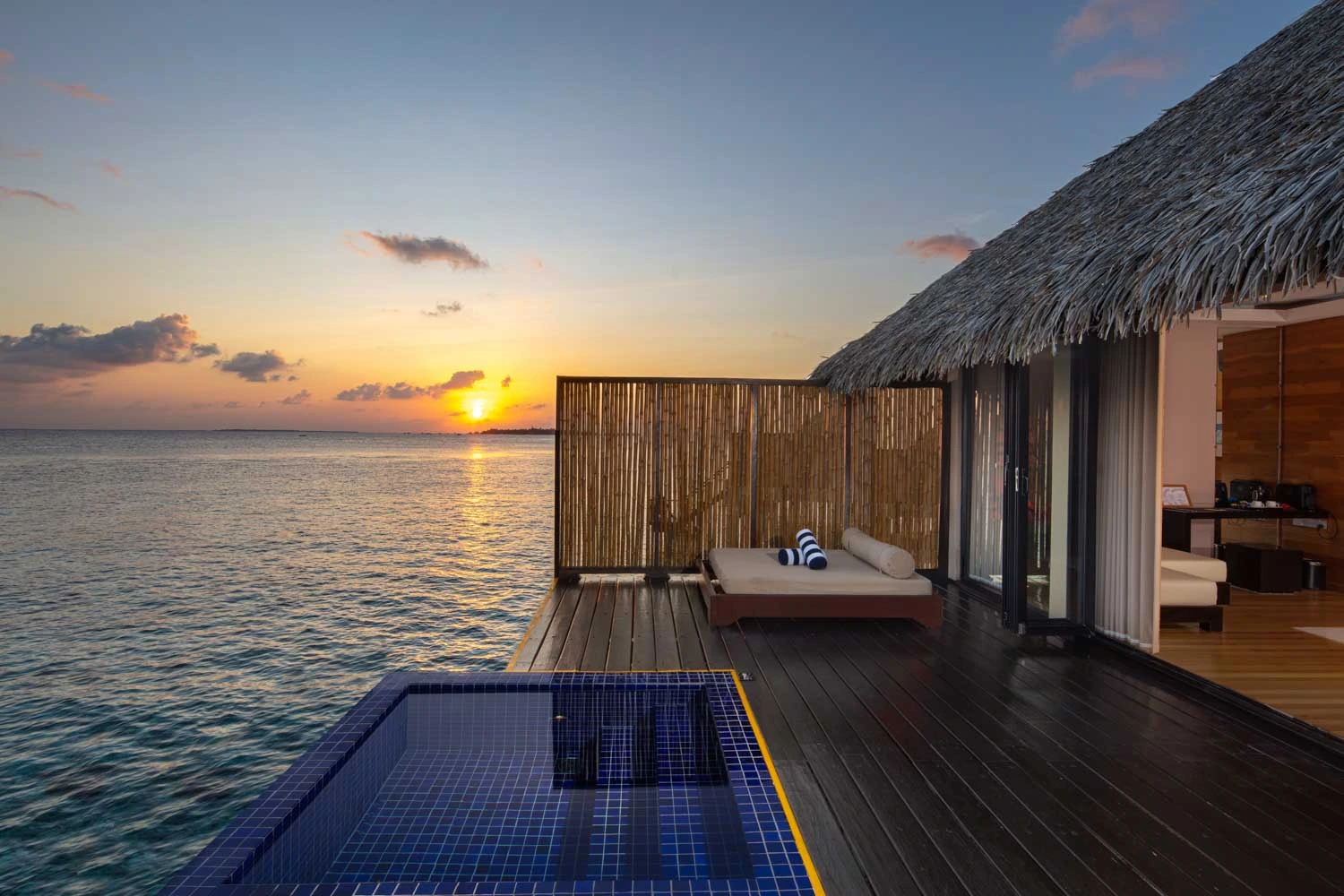 Sunset villa with pool overlooking ocean water