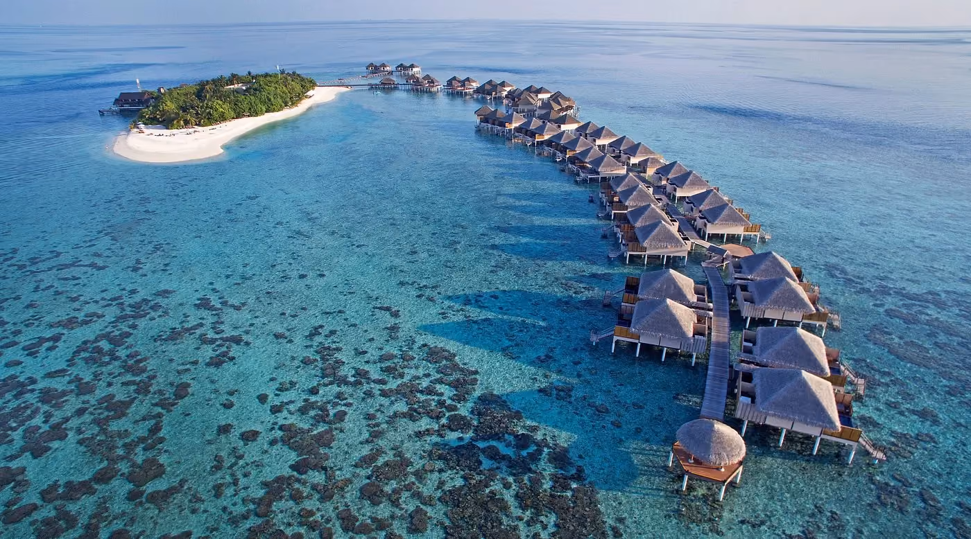 Adaaran resort with water bungalows and island in blue ocean