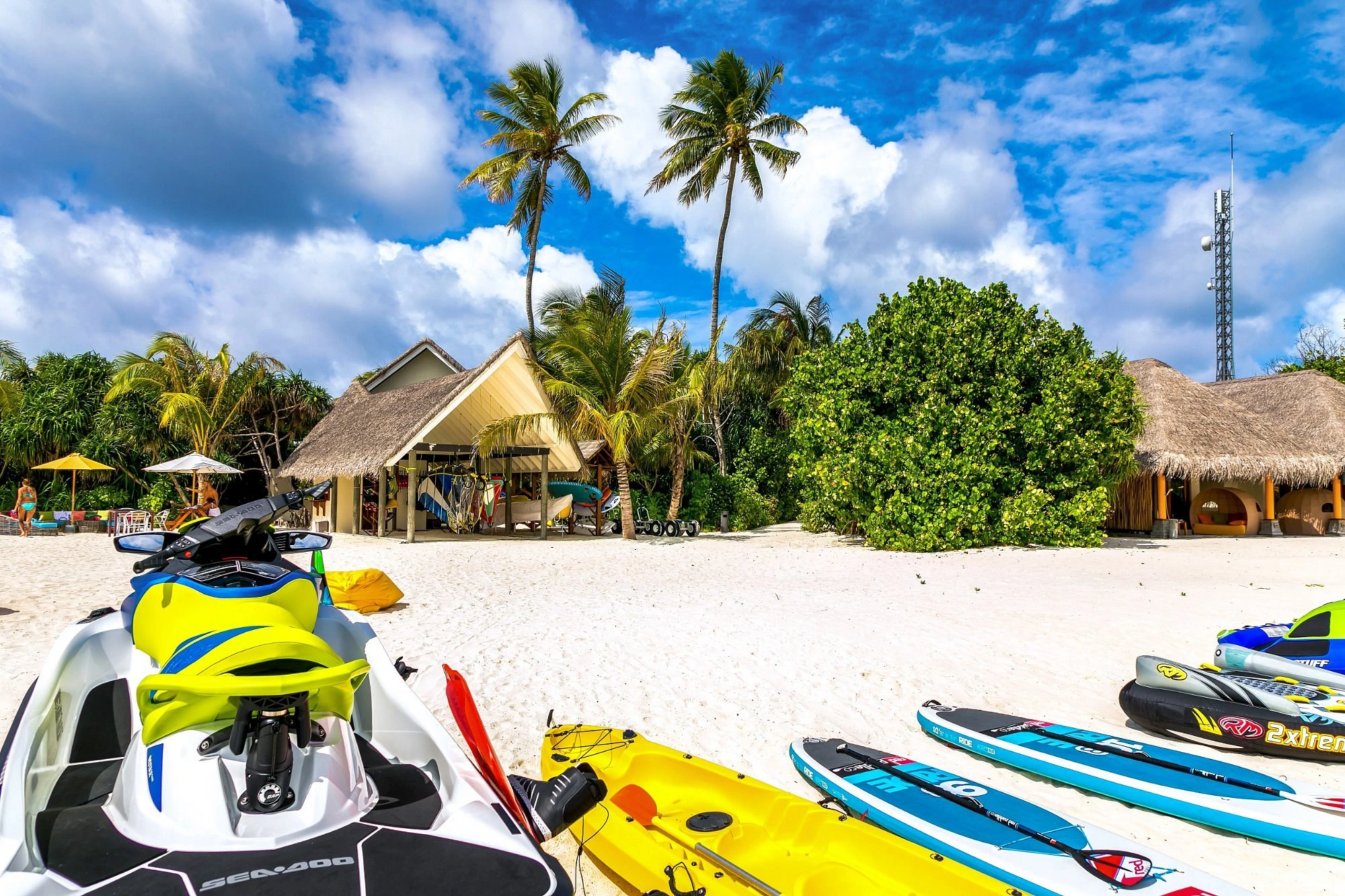 Jet skis and kayaks on sandy beach resort