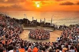 Kecak dance performance at sunset with large crowd watching