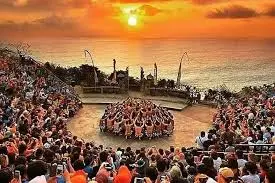 Kecak dance performance at sunset with large crowd watching