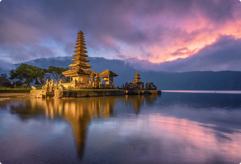 Golden temple reflected in still lake at sunset, Indonesia