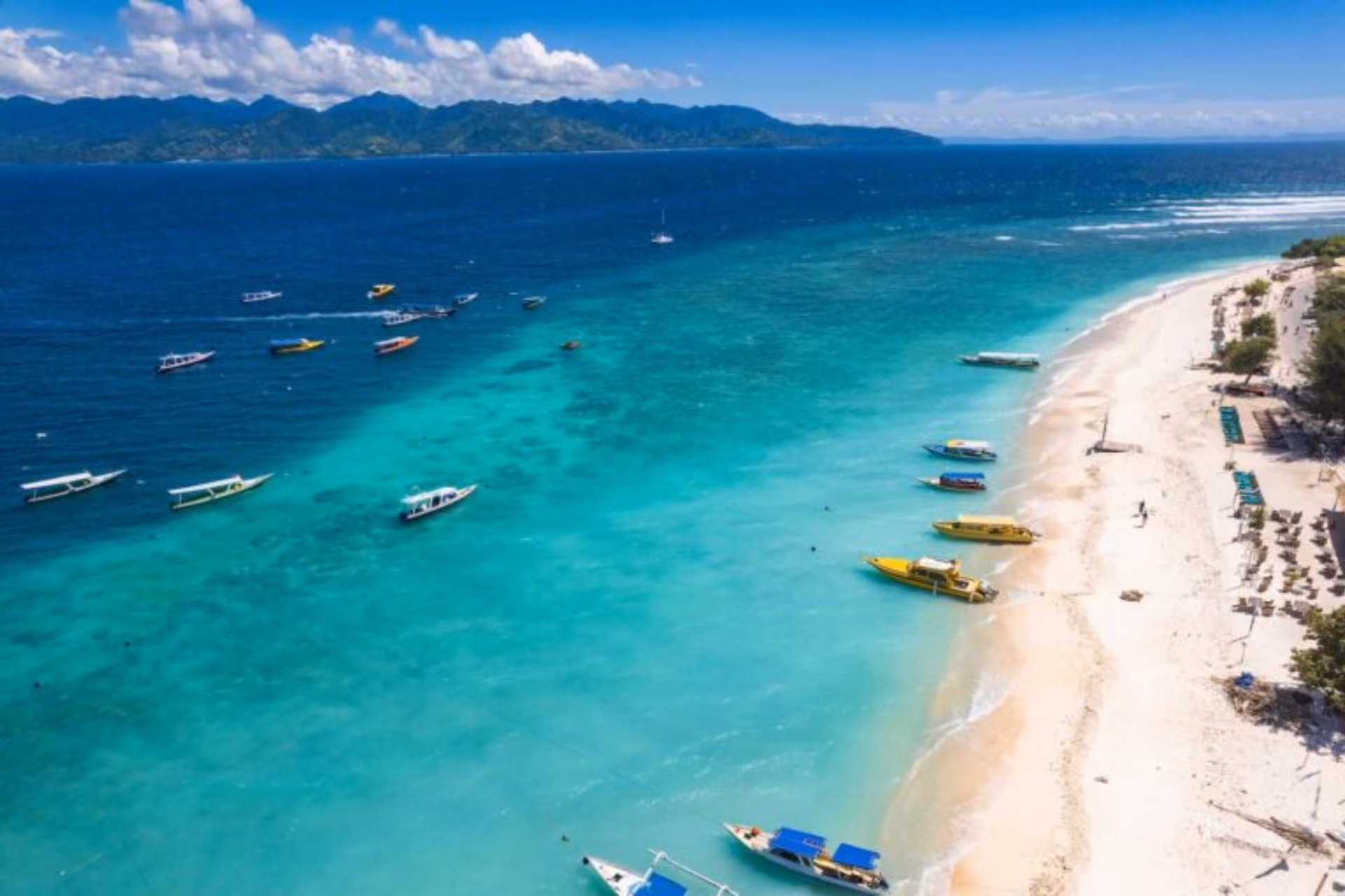 Colorful boats on clear blue water at Gili Island