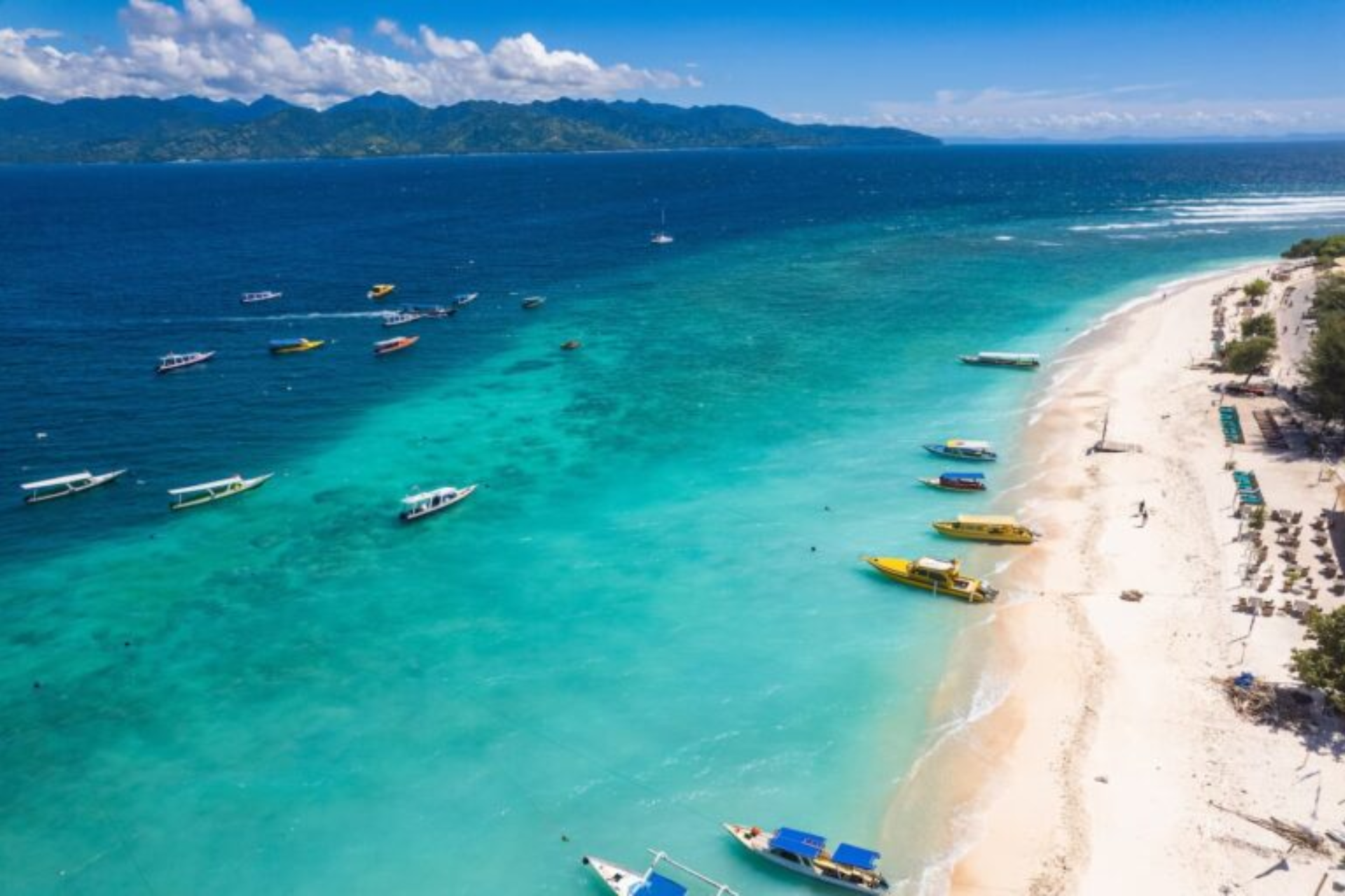 Colorful boats on clear blue water at Gili Island