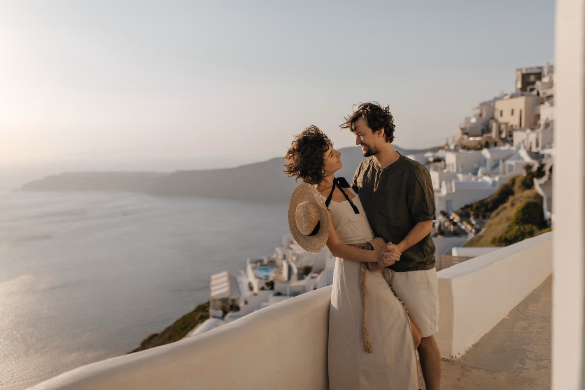 Couple enjoying a romantic sunset in Santorini, Greece — best honeymoon destination to visit in June