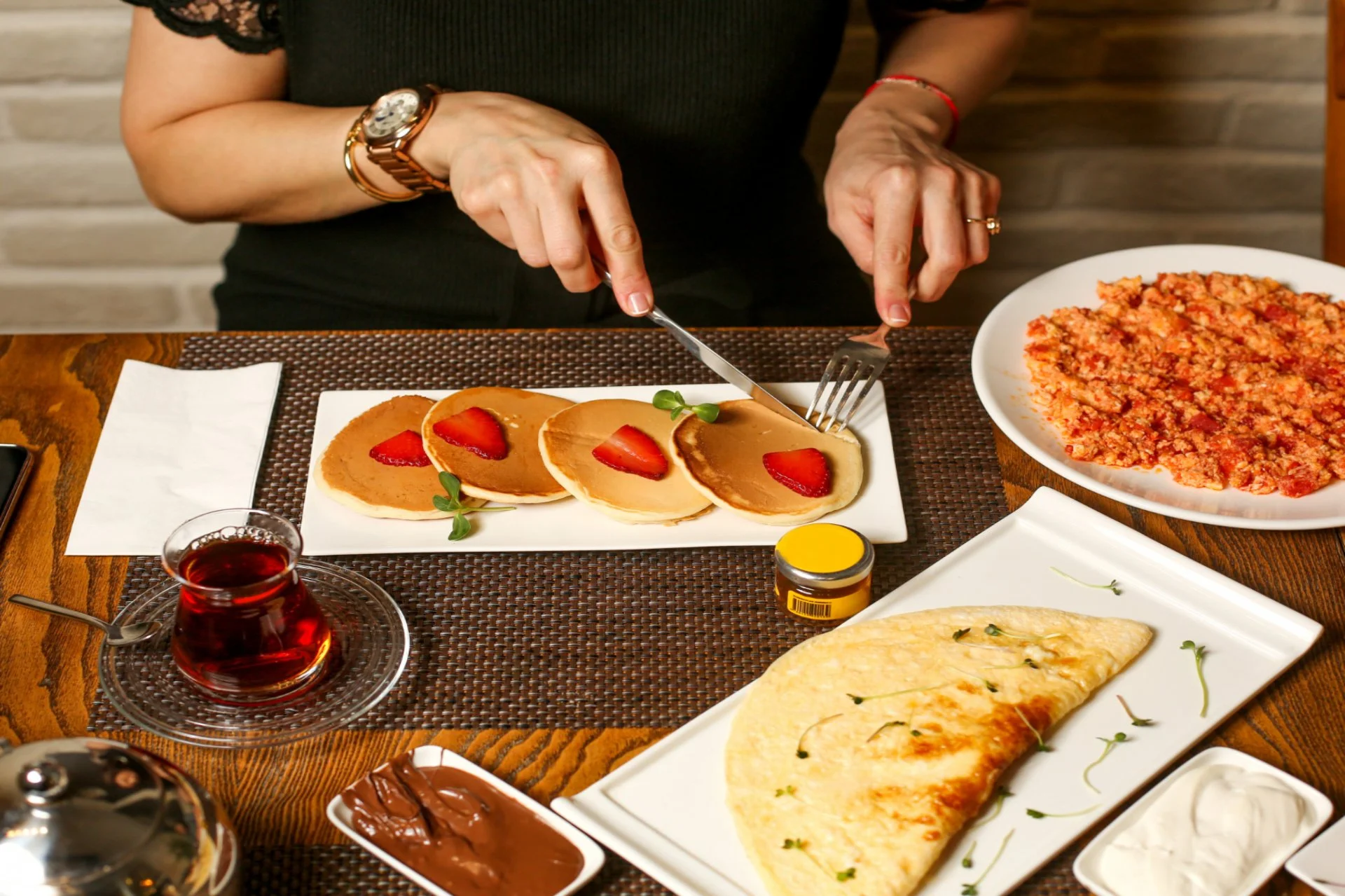 Traditional Georgian breakfast spread with pancakes, omelette, and tea — cuisine options in Georgia for Indian travellers