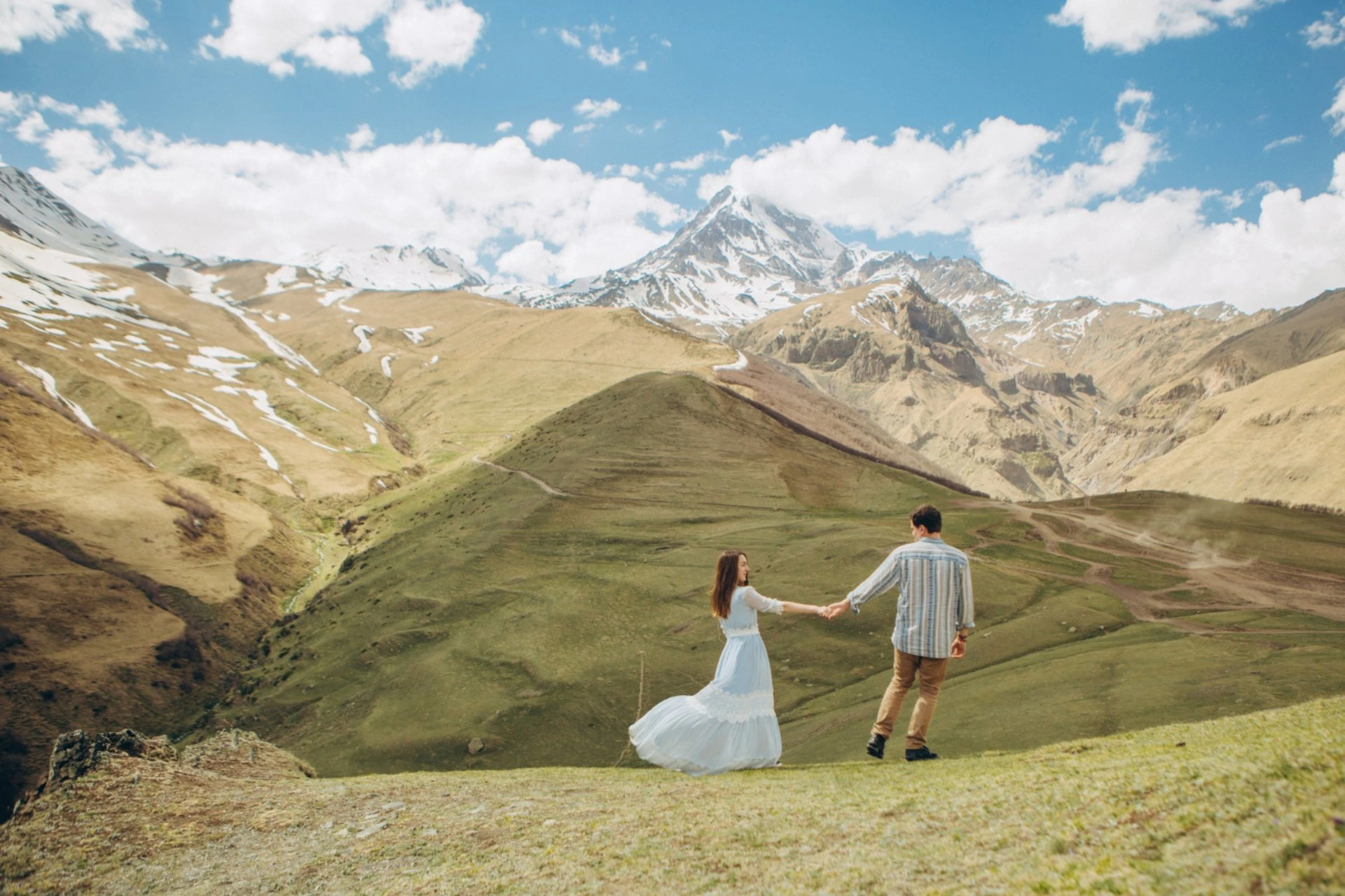 Couple enjoying a scenic honeymoon in Kazakhstan’s mountain landscapes during a July getaway