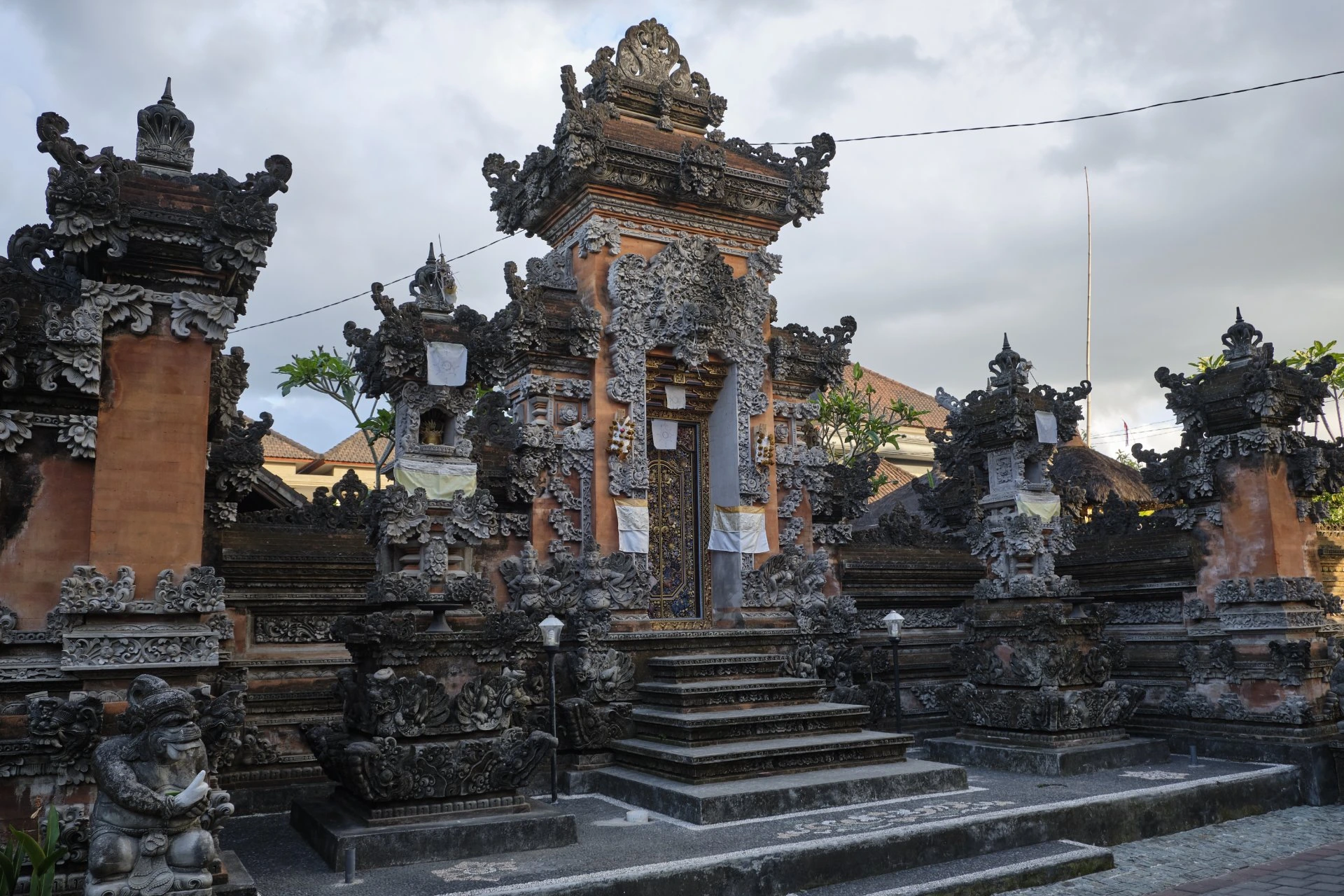Balinese temple in Ubud surrounded by detailed stone carvings during Bali vs Maldives in July comparison