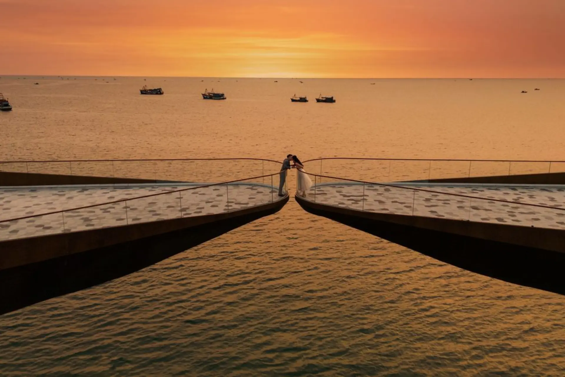 couple standing on the Kiss Bridge in Phu Quoc, Vietnam