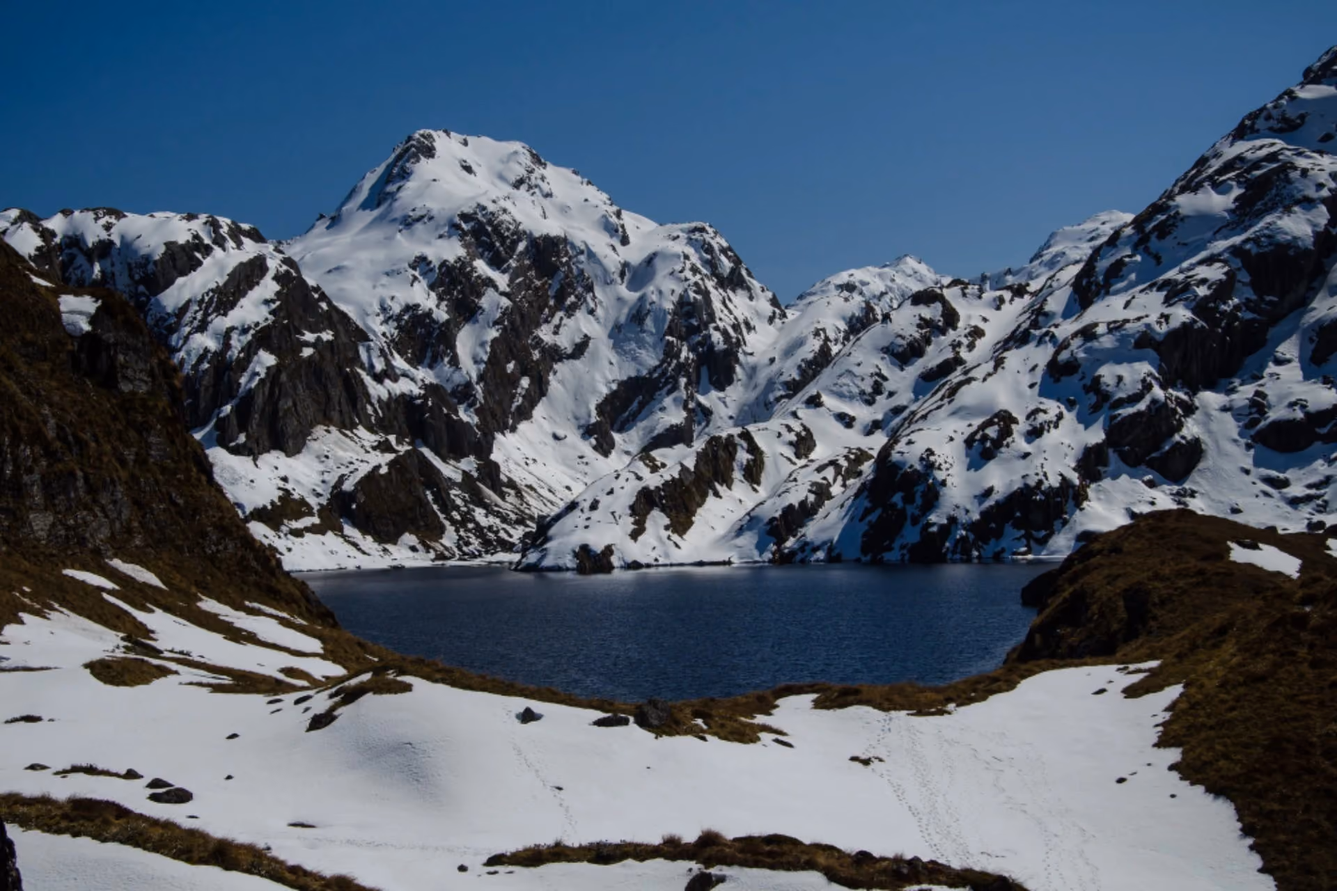 New Zealand vs Switzerland in December showcasing breathtaking snow-capped mountains and alpine scenery