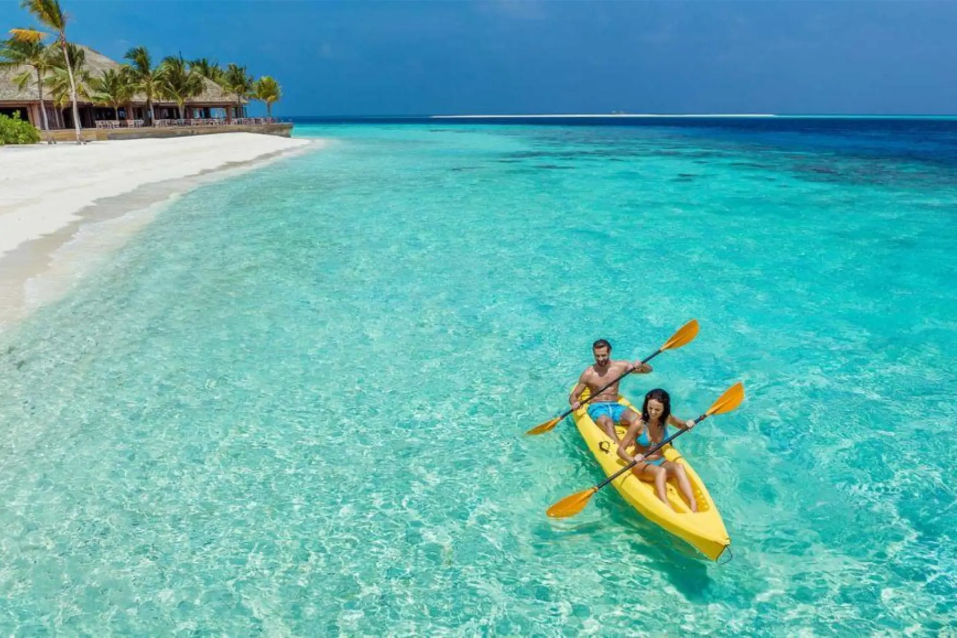 couples enjoying transparent canoeing in Maldives