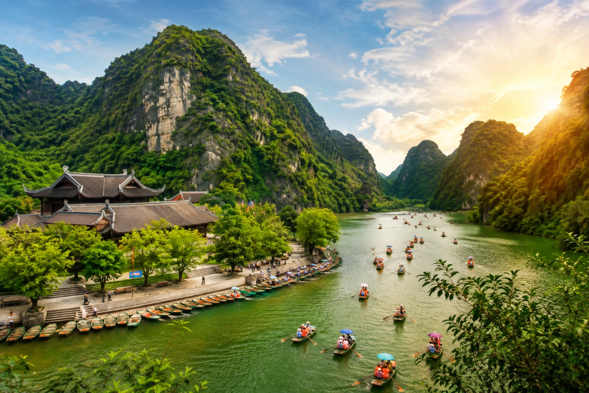 Ninh Binh landscape with limestone karst mountains, green river, traditional pagoda, and boats carrying visitors.