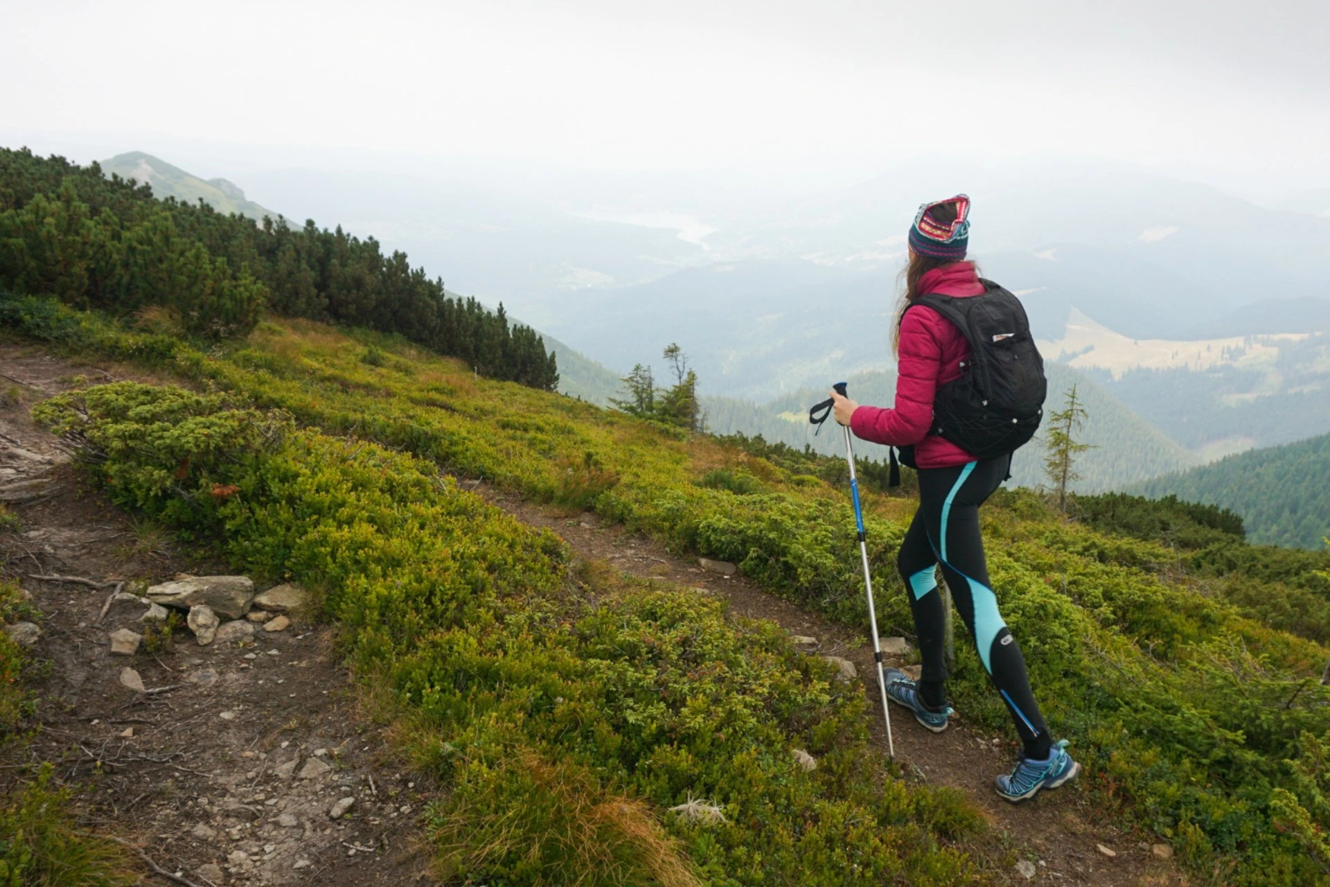 Hiker exploring a scenic mountain trail in New Zealand