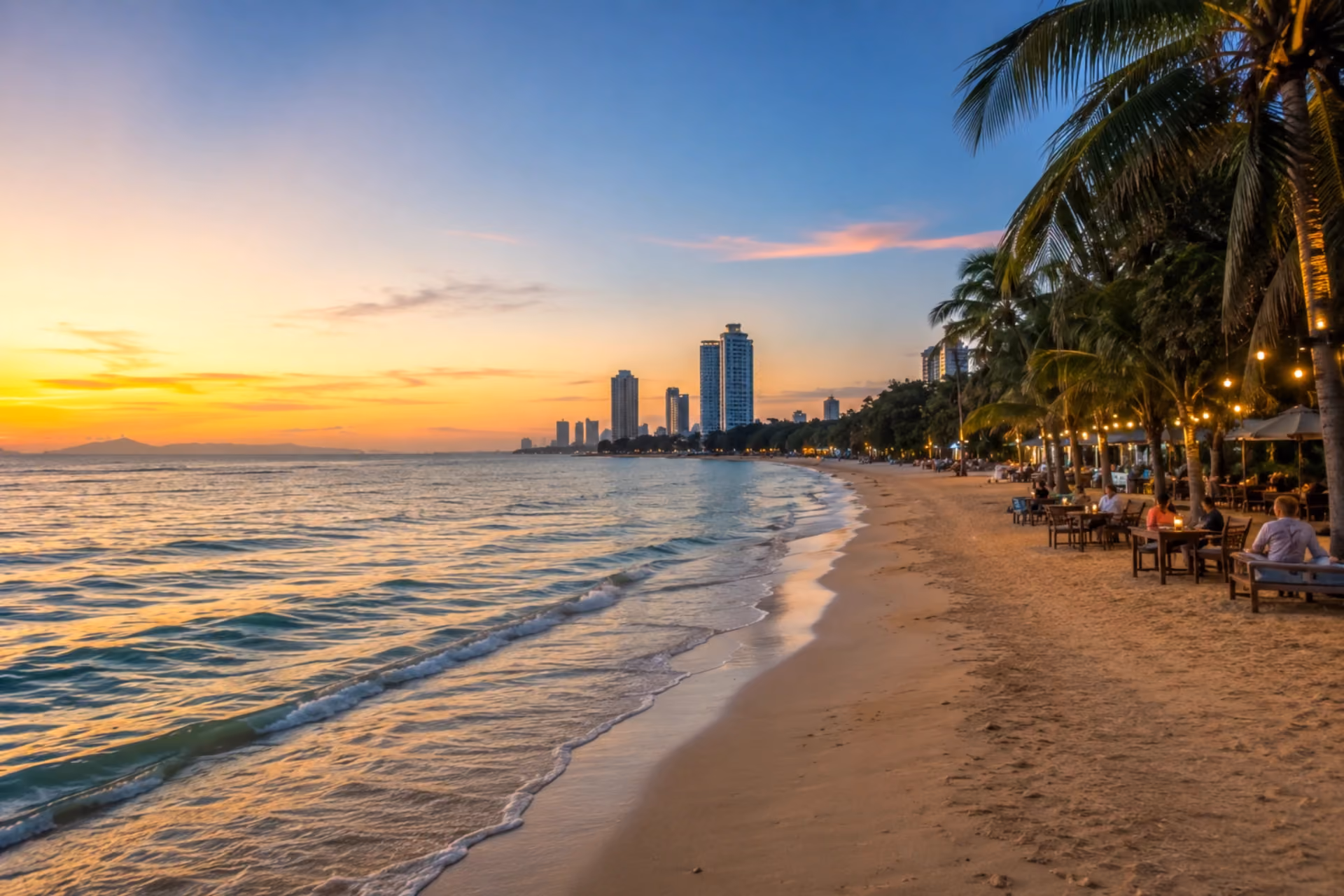 Jomtien Beach with palm trees, seaside cafés, and a calm sunset in Pattaya
