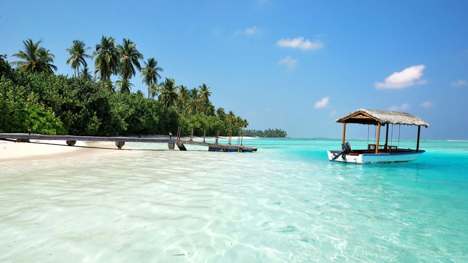Tropical beach in the Maldives with a boat