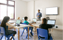 Teacher leading a lesson with students in a bright classroom