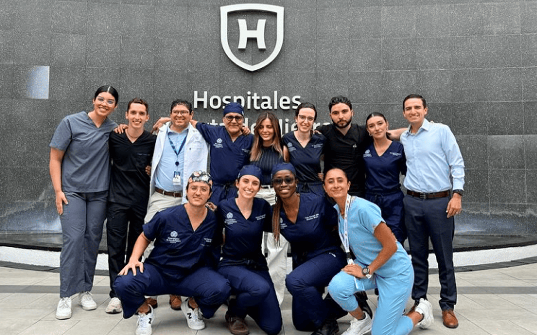 A smiling Mission:Brain team poses in front of Hospitales Puerta de Hierro, celebrating collaboration, compassion, and shared purpose during their medical mission in Guadalajara.