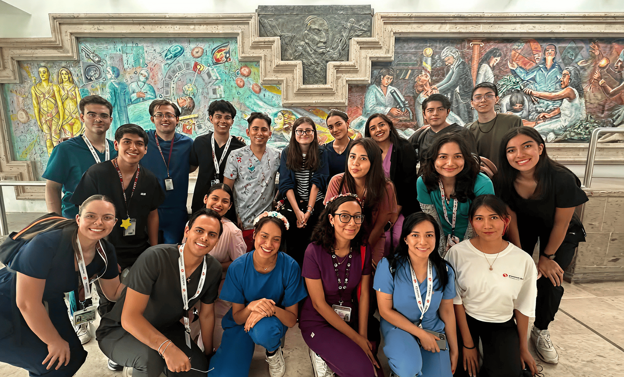 Mission:Brain students and volunteers pose in front of a vibrant mural in Guadalajara, reflecting the cultural richness and passionate spirit behind their medical outreach efforts.