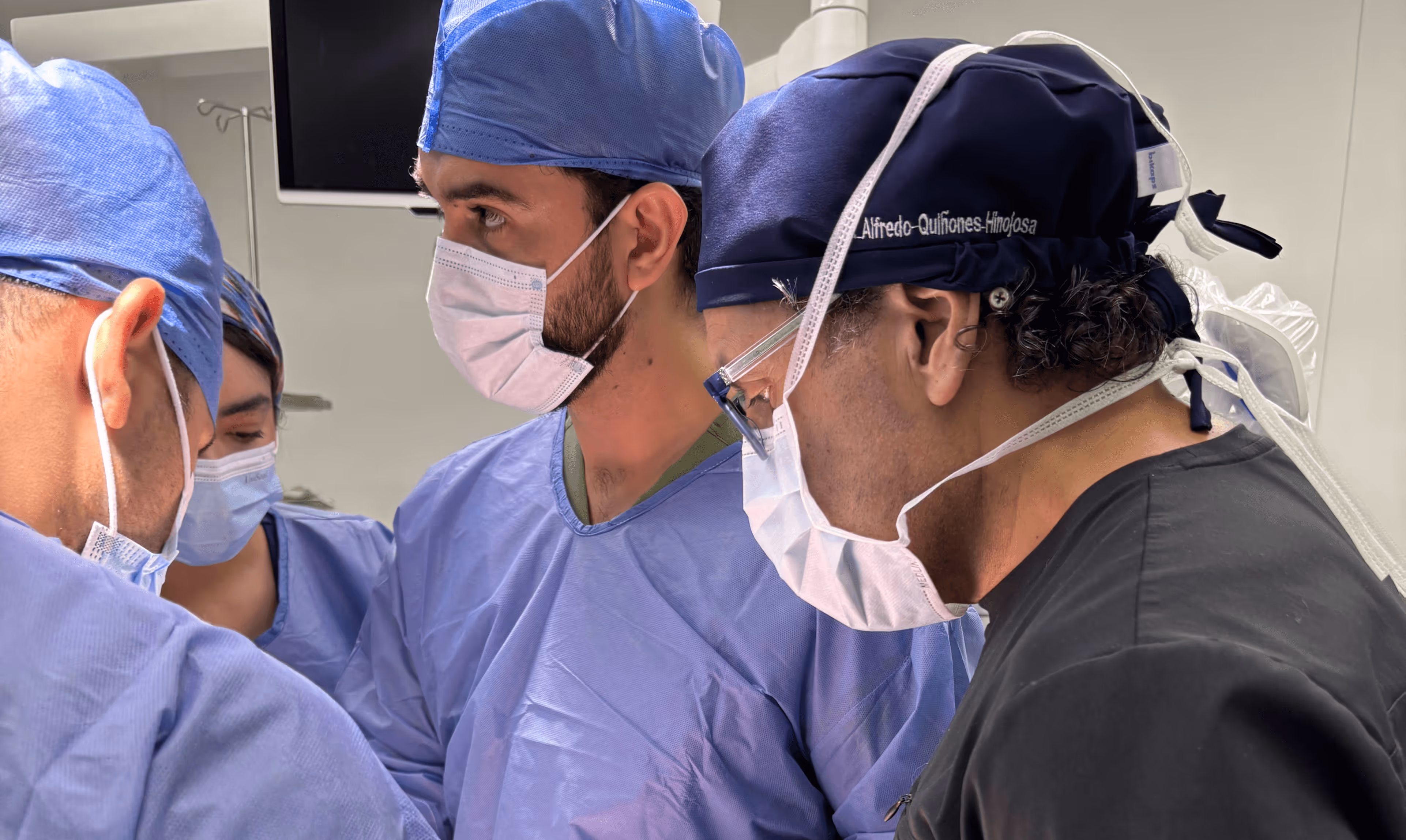 A Mission:Brain physician examines spinal and cranial X-rays while speaking with a patient, highlighting the hands-on care and diagnostic work being done during the Guadalajara mission.