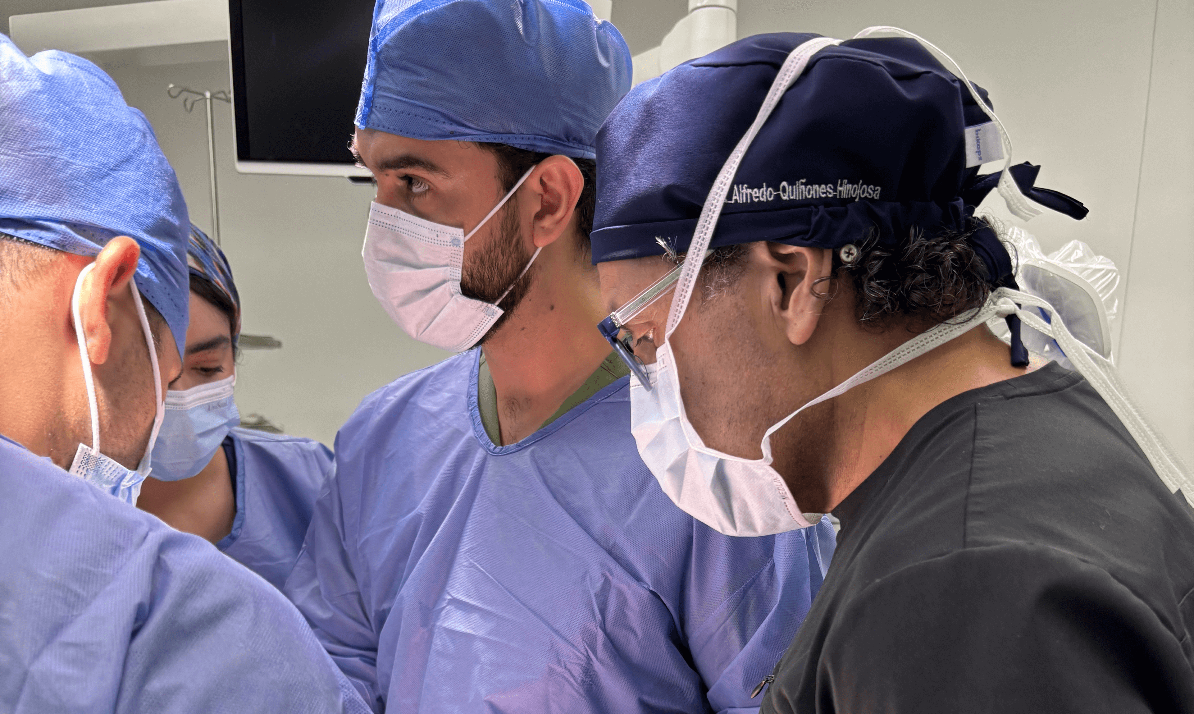 A Mission:Brain physician examines spinal and cranial X-rays while speaking with a patient, highlighting the hands-on care and diagnostic work being done during the Guadalajara mission.