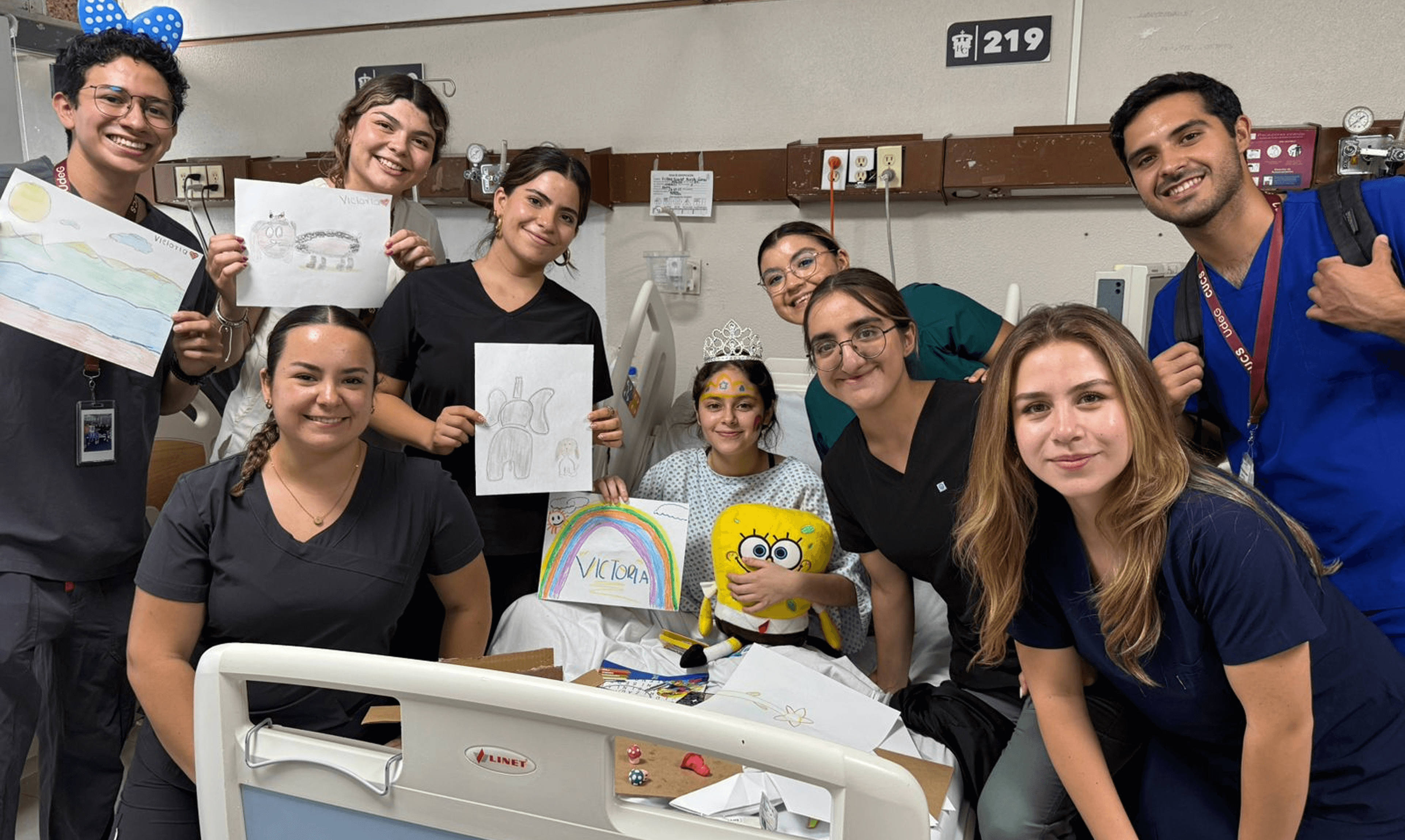 A group of Mission:Brain volunteers and students gather in an auditorium, smiling alongside a senior mentor—capturing the spirit of learning, mentorship, and community during the Guadalajara mission.