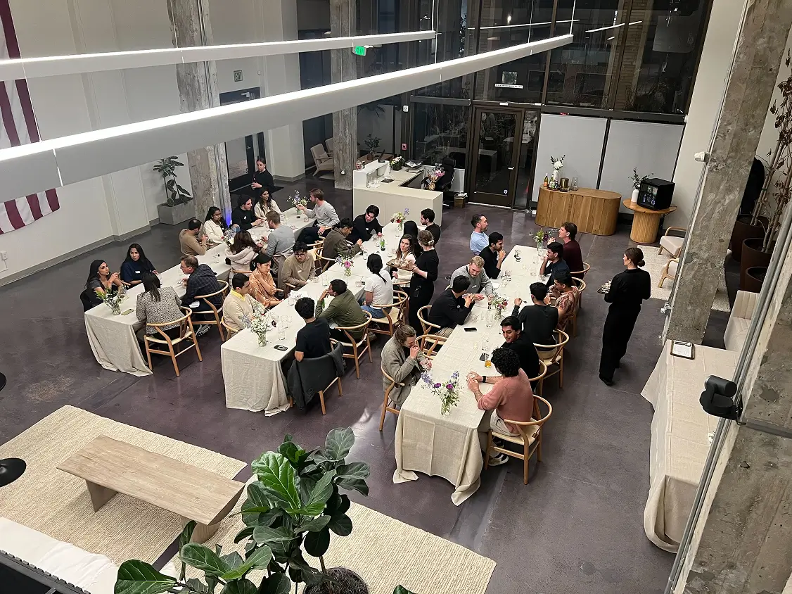 People dining at a large indoor event
