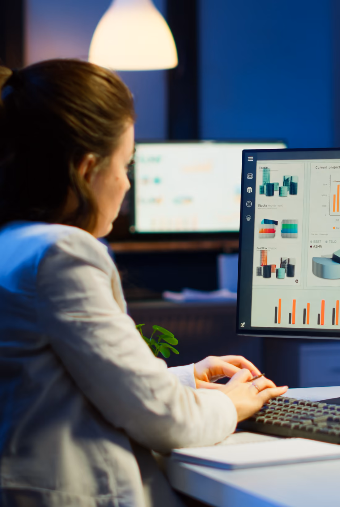 Person analyzing charts and graphs on a computer monitor.