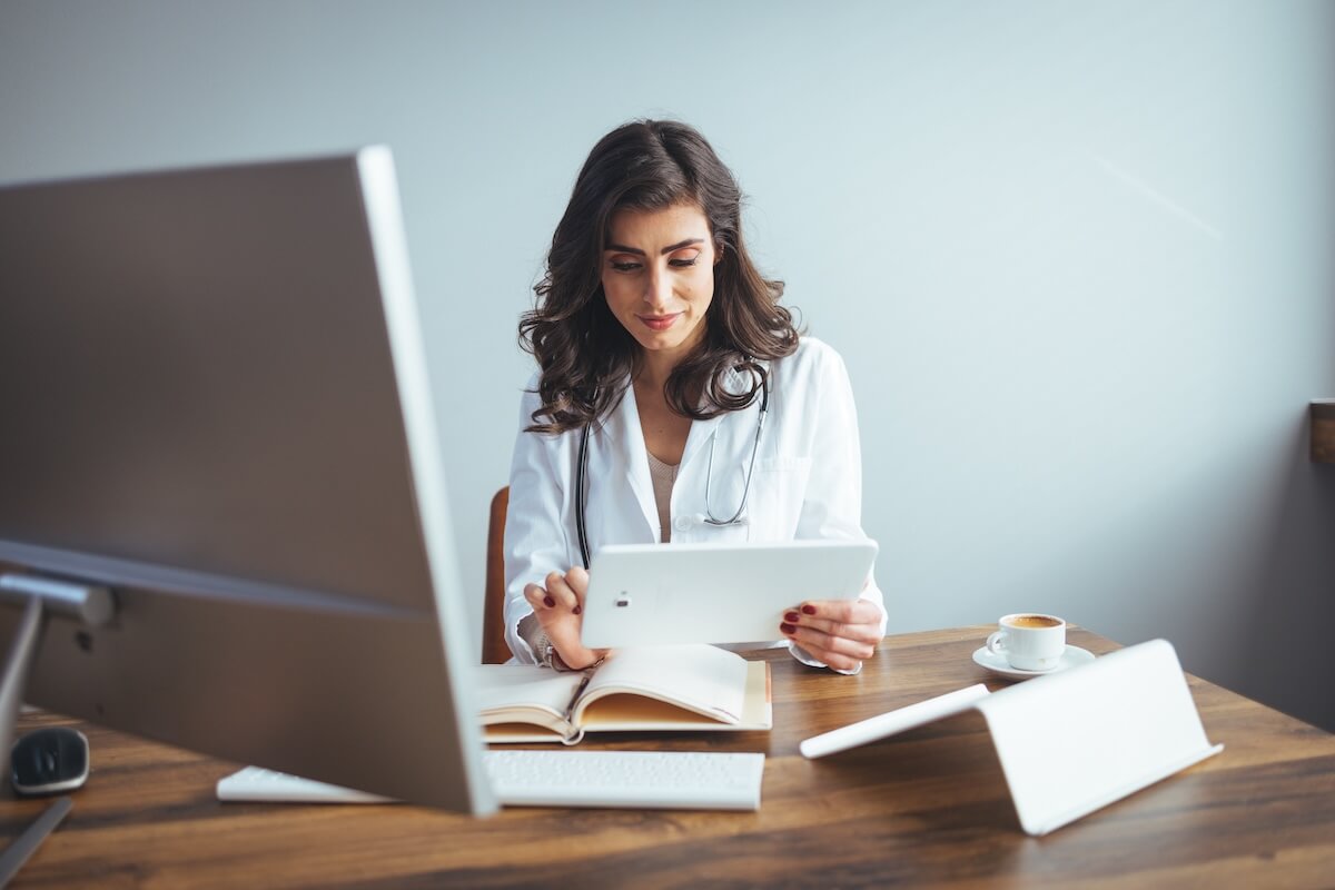 clinician on tablet