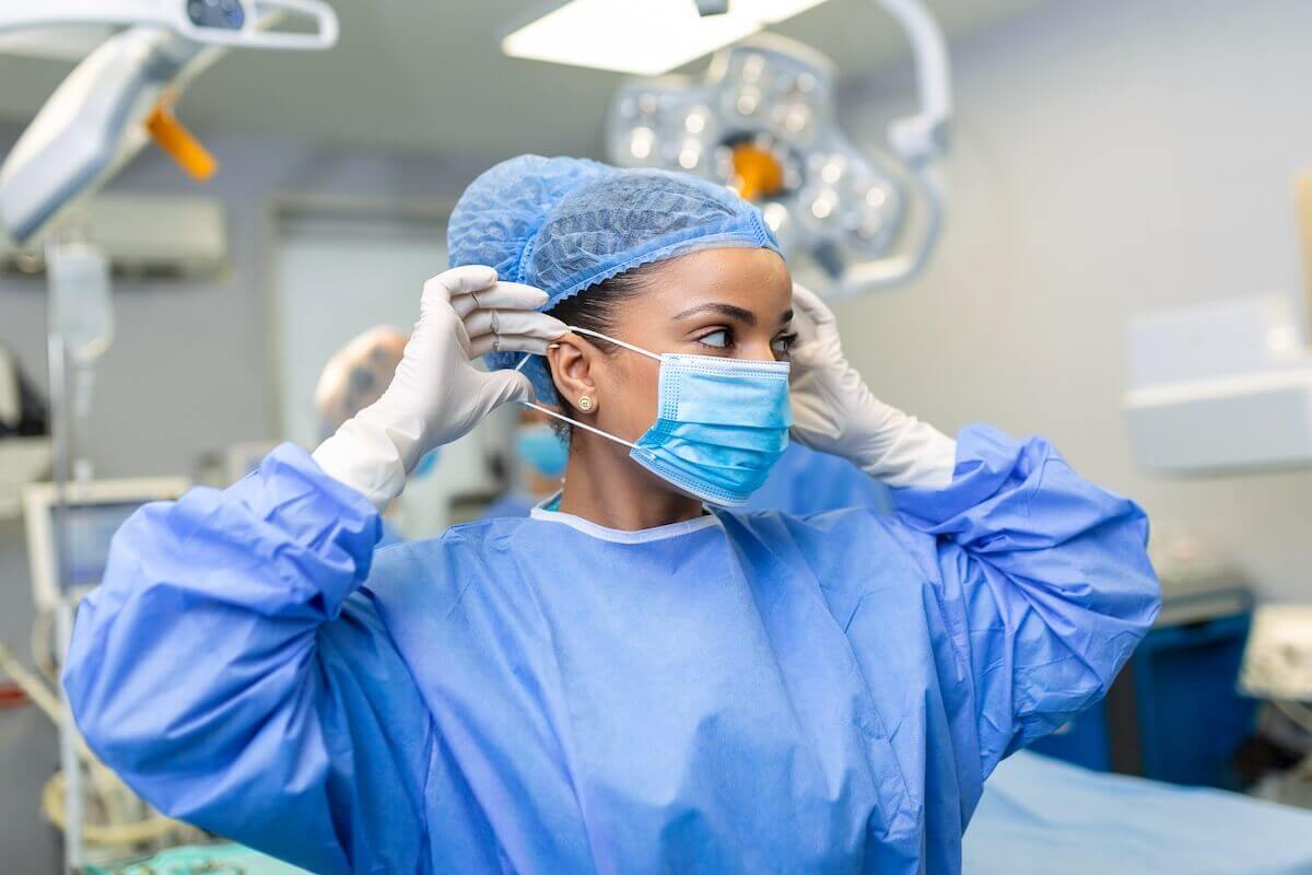 doctor putting on facemask