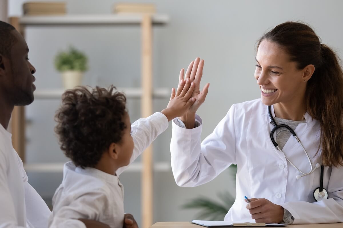 smiling doctor high five patient