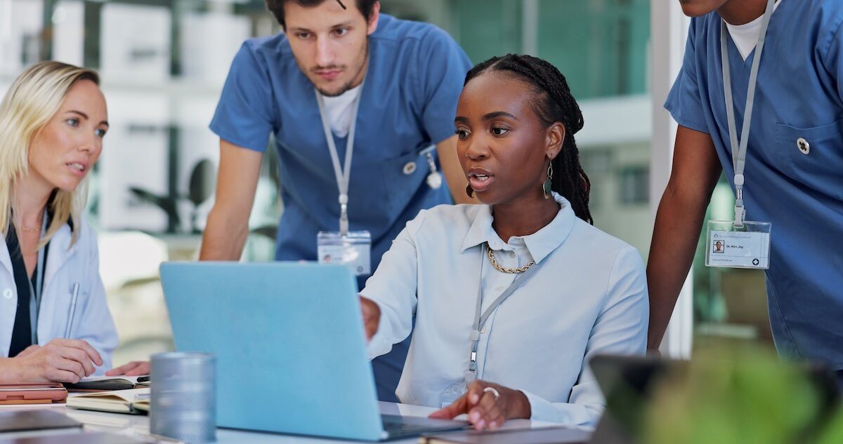 female provider explaining to other providers