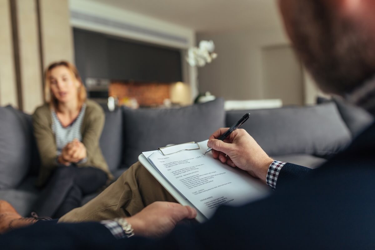 provider taking notes while listening to patient