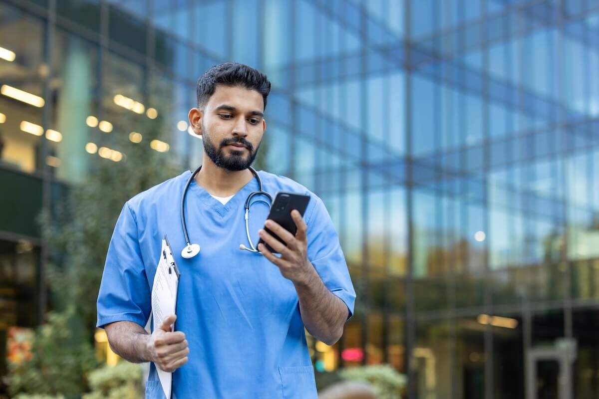 clinician checking phone