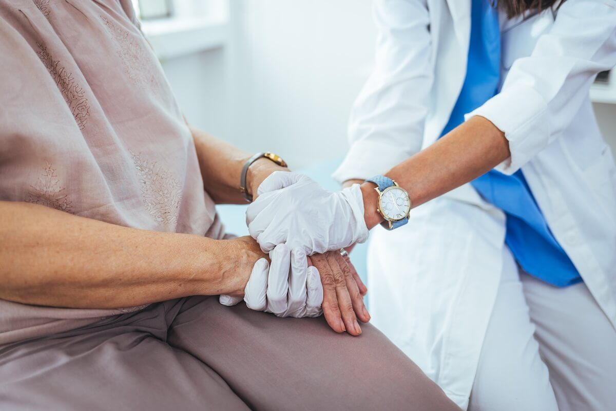 clinician holding hand of patient
