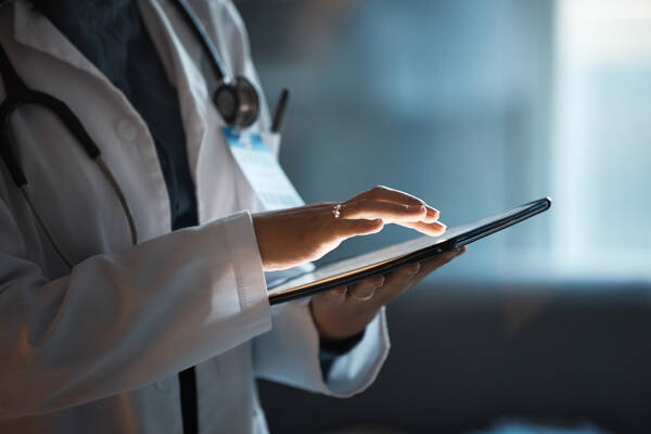 clinician on tablet