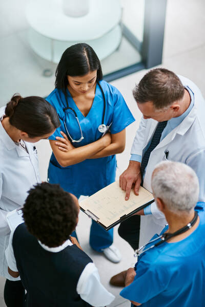 clinicians meeting and discussing report