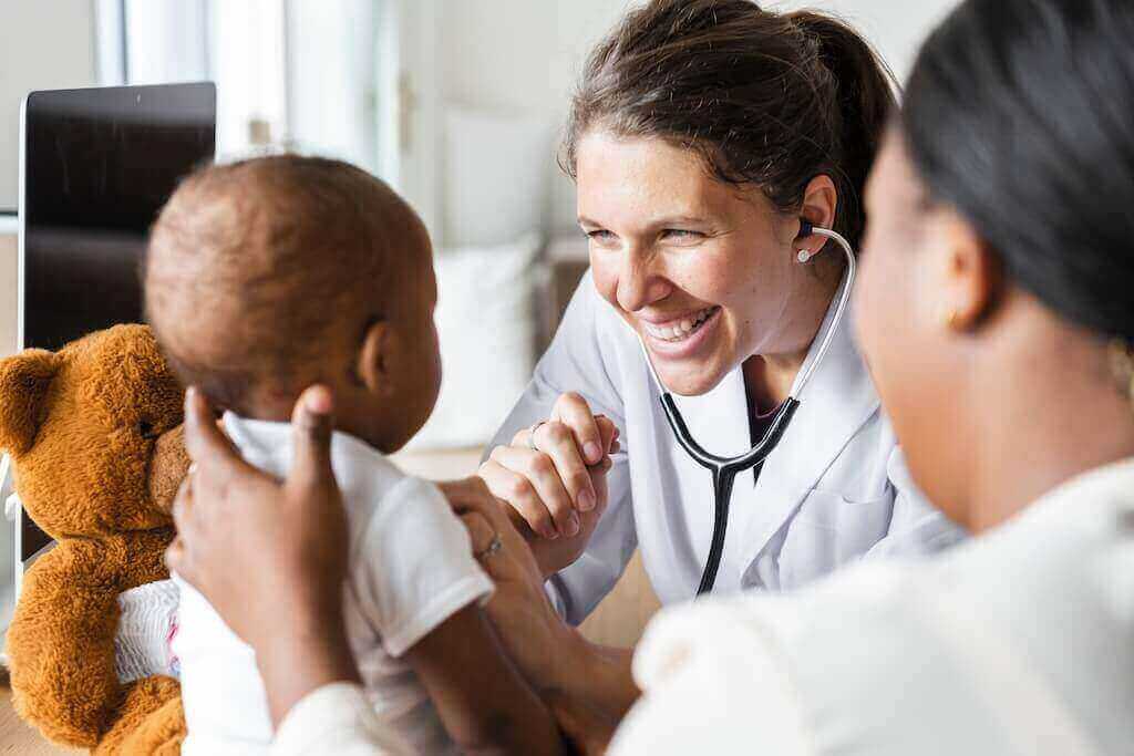 doctor treating infant patient