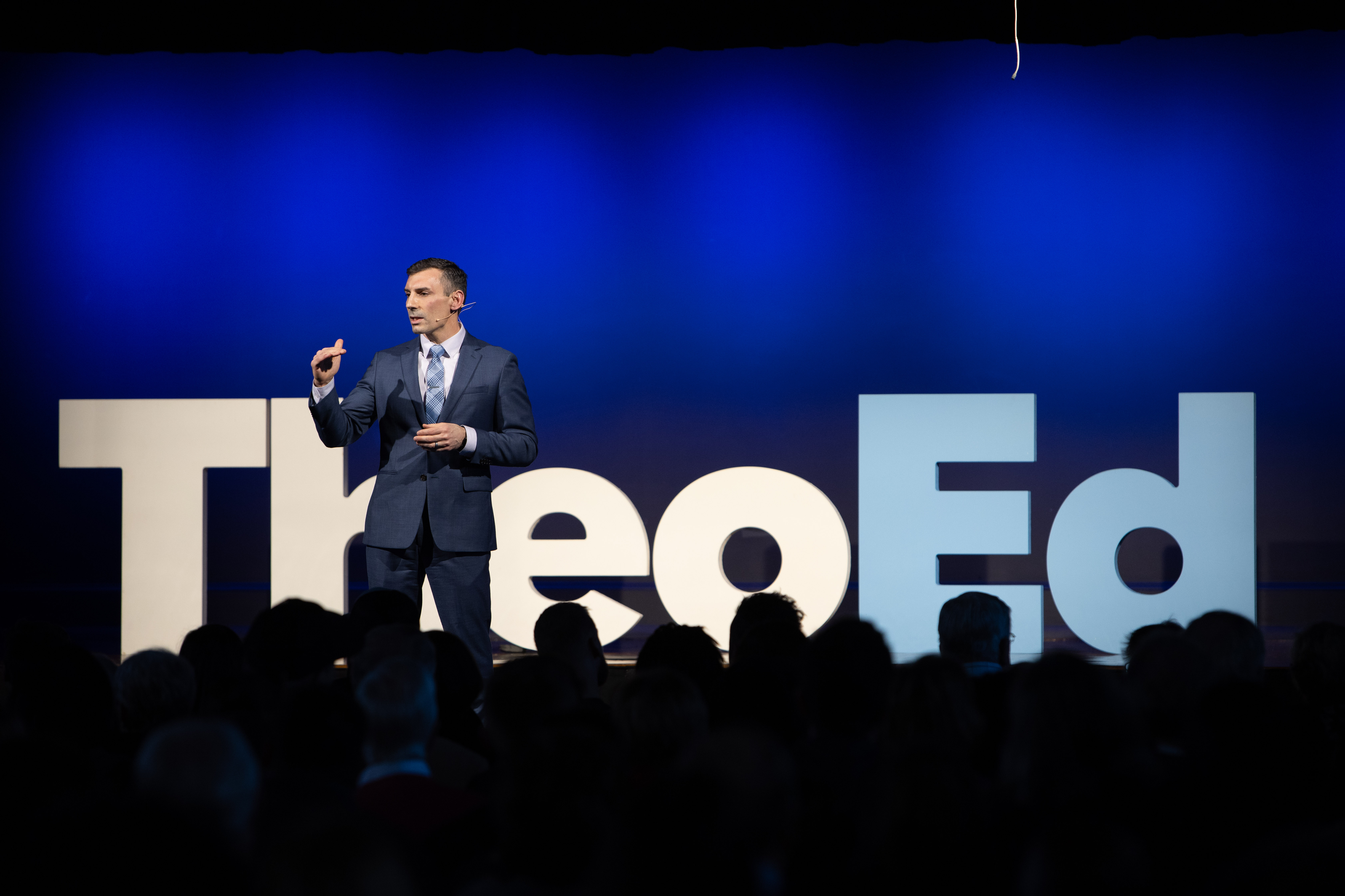 TheoEd live event — audience gathered in community
