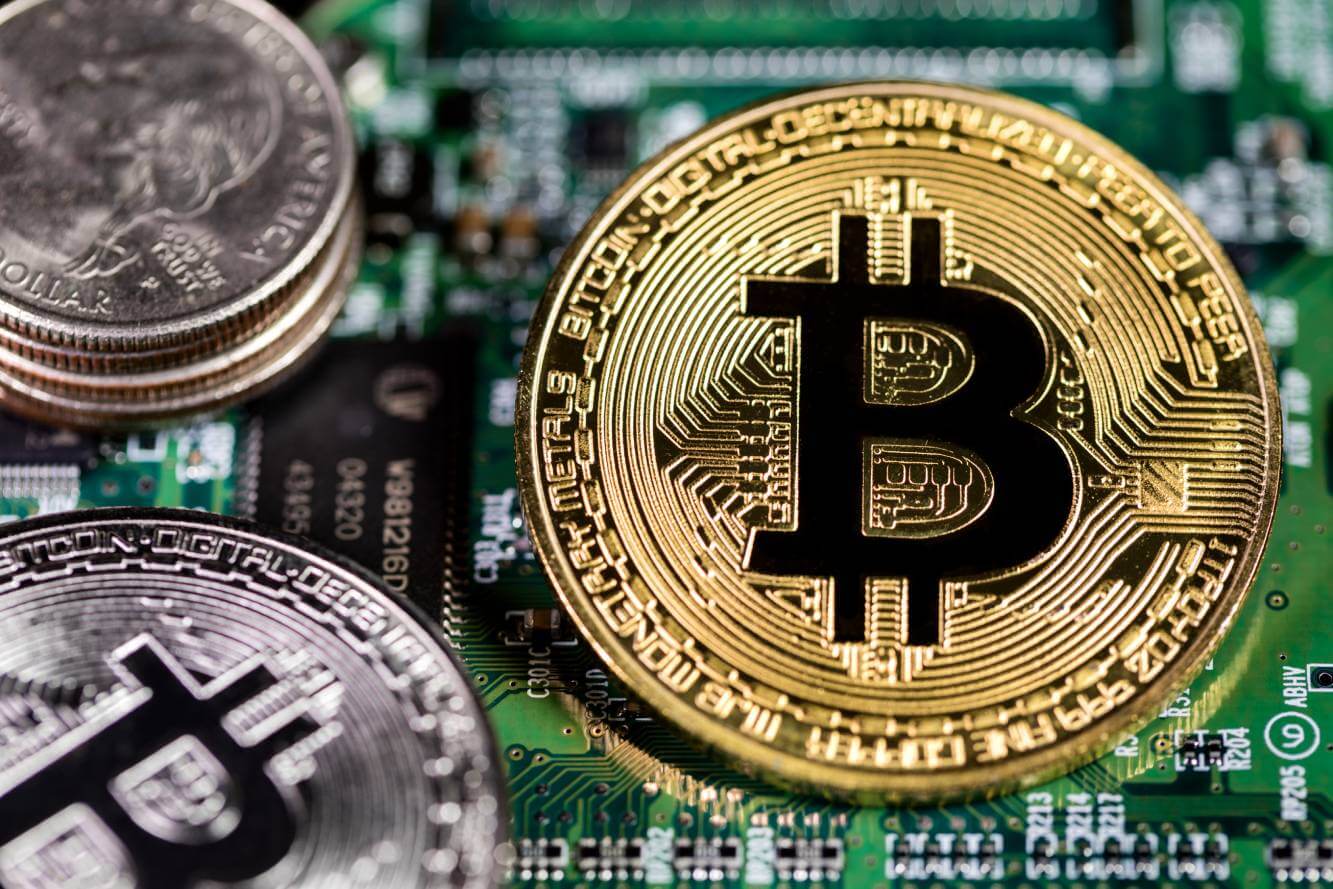 gold bitcoins with computer circuit board background