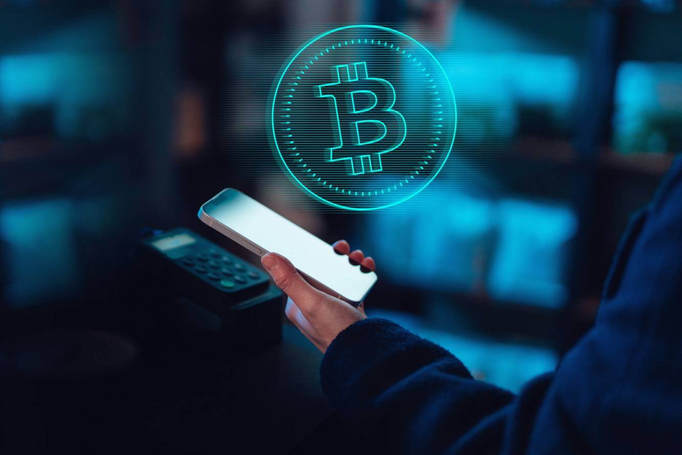 person using their phone to make a purchase with bitcoin