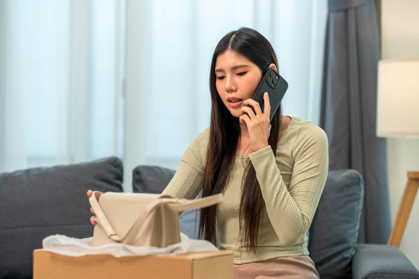 woman on phone talking about a handbag purchase made online