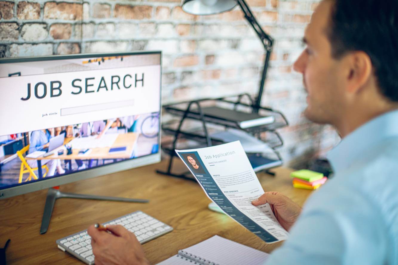 man conducting a job search on his home computer