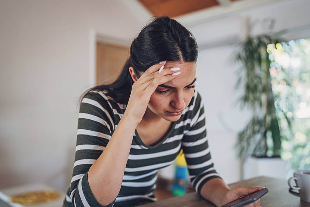 victim of job hunting scam looking at her phone