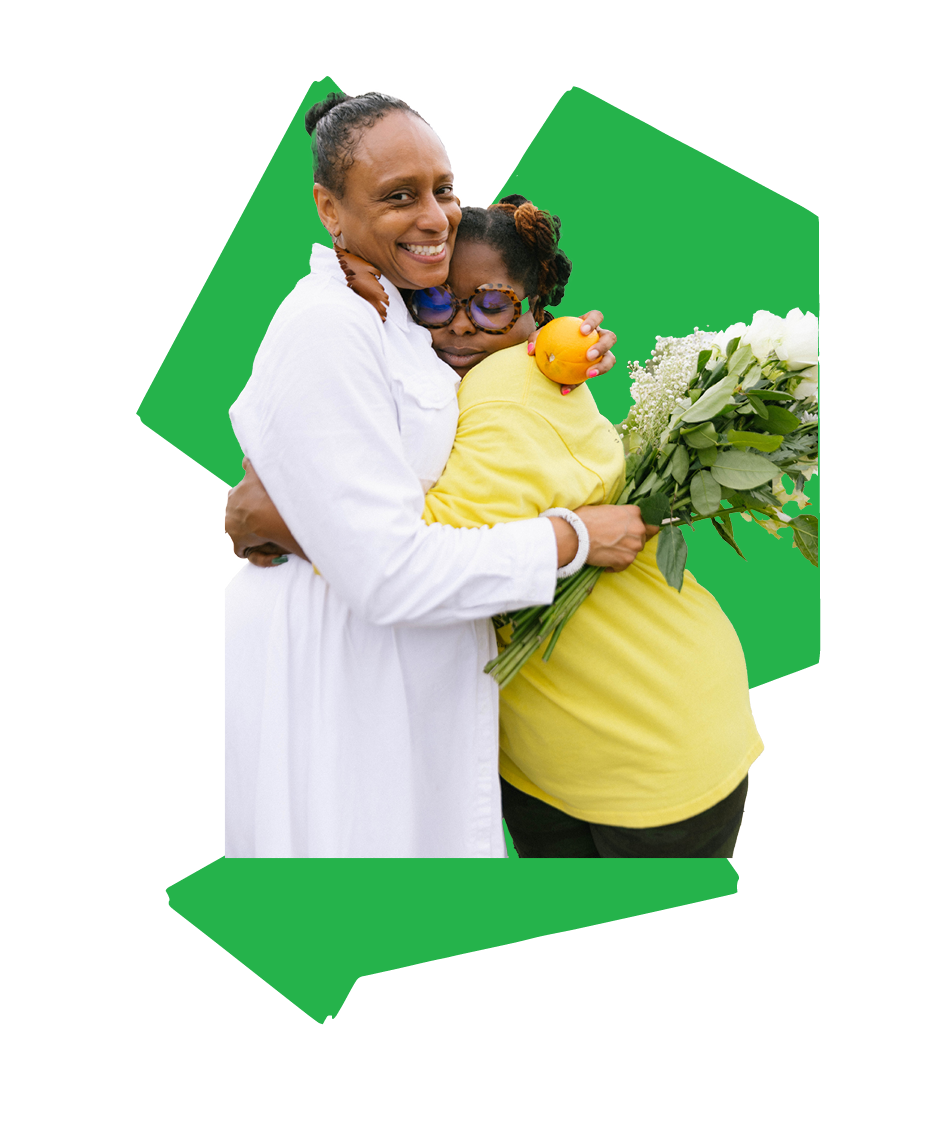 A photograph cutout of Dr. Jasmine Jackson happily hugging another Black woman in appreciation and adoration holding white flowers. Placed over a green rigid geometric shape