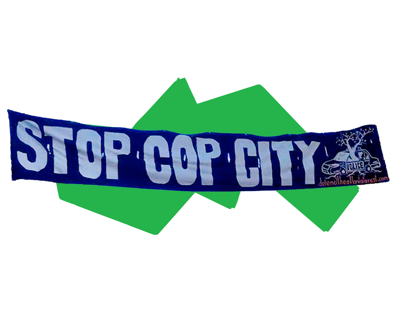 A photograph cutout of a large blue painted sign that says “Stop Cop City”