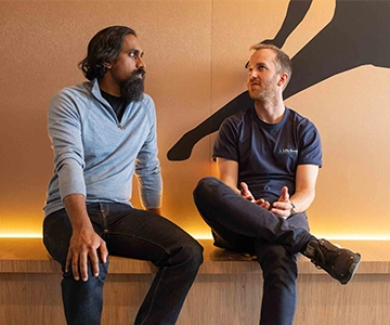 Image of Shane Guna talking with a client at thier clinic.